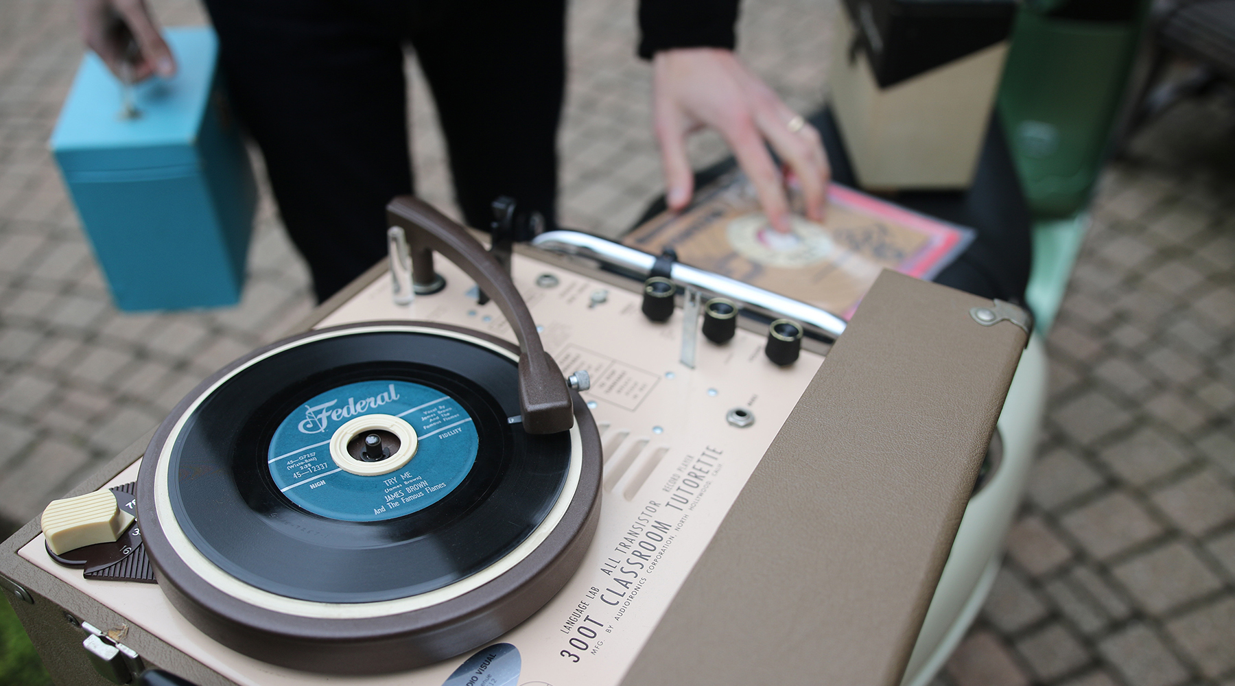 A 45 RPM record playing on a vintage portable turntable